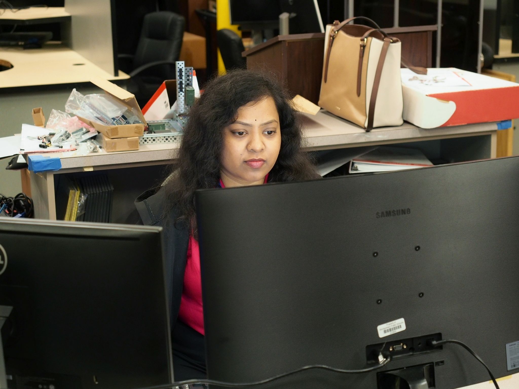 Ms. Shivani working in her office at Brewbaker Technology Magnet High School, preparing engineering lessons and projects.